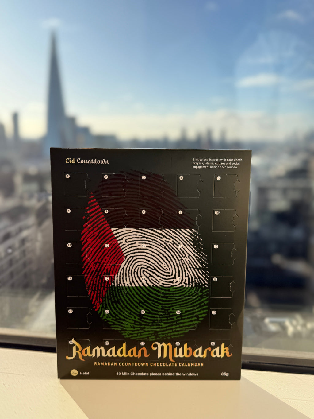 Ramadan Mubarak chocolate calendar with a blurred cityscape in the background